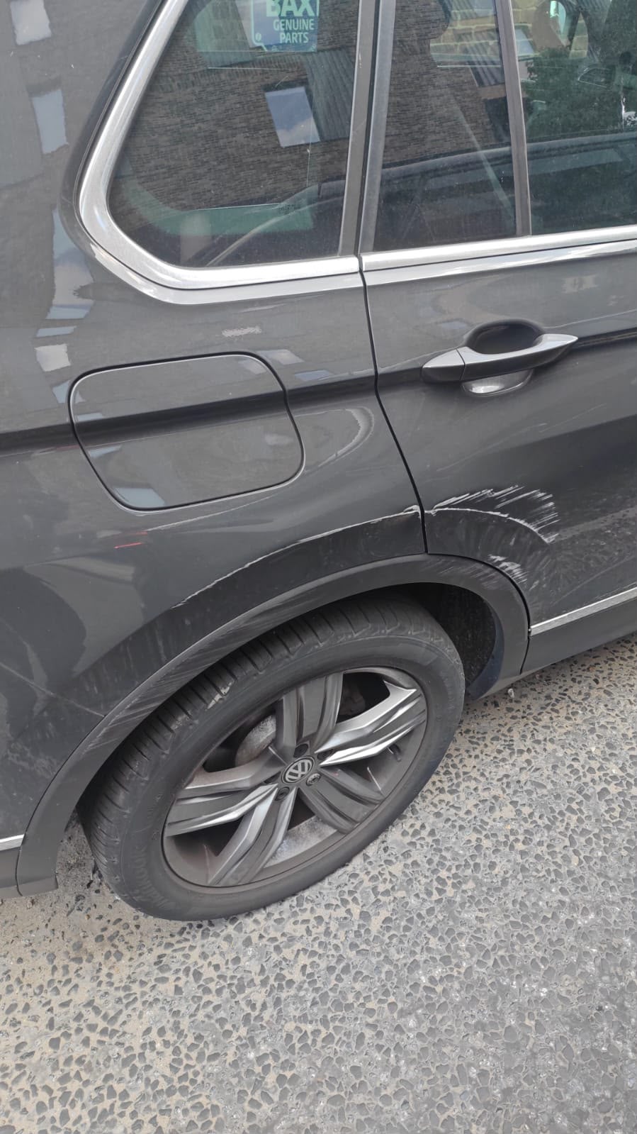 Grey car with rear quarter panel and wheel arch scuffs